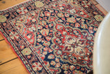 Quatrefoil center medallion and scalloped floral design of vintage Sarouk rug in blue, red, and green.