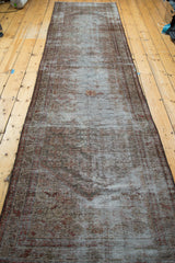 Intricate borders on a distressed vintage Malayer runner with faded charcoal brown and moss green.