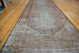 Distressed Persian Malayer runner, faded intricate design with charcoal, moss, and ivory tones.