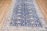 Distressed navy Khotan runner with ivory pomegranate and blossoming floral patterns.