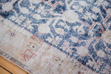 Distressed Khotan runner texture with geometric pomegranate and floral designs in navy and ivory.