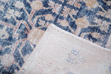 Distressed Khotan runner, showing its geometric navy and gold pattern and hand-knotted foundation.