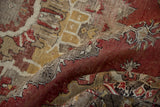 Distressed texture and faded cinnabar red, gold, and ivory patterns on an Oushak rug.