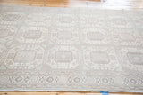 Distressed Kaisary carpet with ivory, blush, and grey geometric octagonal guls.