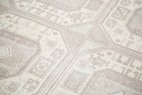 Distressed texture and geometric octagonal guls in soft ivory and pastel hues.