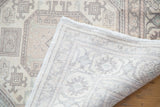 Distressed Kaisary carpet pile texture with faded pastel guls and hand-knotted back.