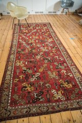 Vintage Oushak runner detail: madder red field, rectilinear pinwheel boteh motifs, tribal border design.