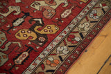 Vintage Oushak runner, madder red field with tribal pinwheel boteh design and intricate border.