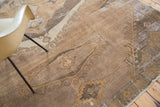 Distressed Oushak carpet section, showing intricate geometric patterns and faded earth tone palette.