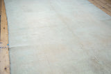 Distressed hand-knotted Oushak carpet, with soft faded apricot field texture.