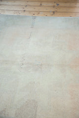 Faded peach apricot pile with subtle green hues and visible re-piling.