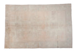 Distressed hand-knotted Oushak carpet with faded peach apricot field and triple star medallion.