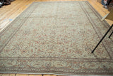Distressed Turkish Kaisary rug corner, faded grey-green field and delicate allover floral design.