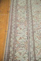 Distressed Turkish Kaisary carpet border with muted floral patterns on a faded grey green field.