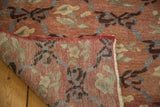 Folded vintage Oushak runner reveals hand-knotted back and blush floral lattice pile.