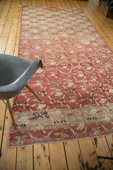 Oushak runner end with floral ribbon lattice, showing sun-softened blush tones and fringe.