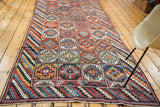 Vibrant hand knotted Vintage Kurdish runner with geometric gul motifs and striped borders, 4'5