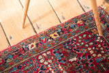 Luxuriant red wool pile of a hand-knotted vintage Sarouk rug with colorful floral motifs.