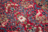 Luxurious hand-knotted wool pile with red, aqua, green floral motifs.