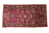 Vintage Sarouk rug mat with a cherry red field, central medallion, and vibrant floral arrangements. 2'2