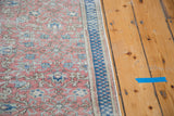 Distressed texture and intricate floral motif with navy border of a Kaisary carpet.