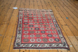 Vintage Oushak rug displaying Veramin-style floral cross sections in red, ivory, and earth tones.