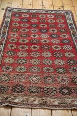 Patterned lower section of the Oushak rug, showing floral cross sections and fringe.