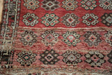 Vintage Oushak rug with red, brown, ivory floral cross-sections, and patterned horizontal band.