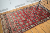Vintage Oushak rug detail: red field, Veramin style floral cross sections, earth tones, and ivory.