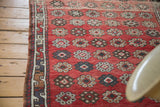 Vintage Oushak rug with veramin-style floral cross sections and detailed border.