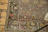 Distressed vintage Oushak runner corner with geometric motifs in cherry red, saffron, and ivory.