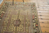 Intricate border and emerging arrow motif in muted gold on a distressed mauve Oushak runner.