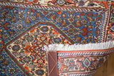 Dense Herati motif in blues and ivory, with fringed edge and reversed turtle samovar border.