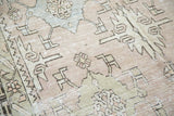 Distressed Oushak pile texture with geometric design in celadon, powder blue, and ivory.