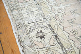 Distressed hand-knotted weave with geometric patterns in charcoal and ivory on a vintage Oushak.