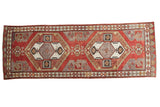 Distressed Oushak rug runner with tribal double medallions in brick red and grey.