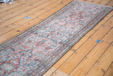 Distressed Lilihan runner showcasing stylized floral medallions in blush, black cherry, and sky blue.