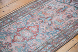 Faded blush rose, cherry red, and brilliant blue floral motifs on a distressed Lilihan runner.