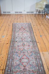 Faded blush rose and sky blue floral medallions on this distressed Persian Lilihan runner.