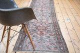 Distressed Lilihan runner with faded blush rose, cherry red, and brilliant blue stylized patterns.