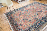 Distressed Heriz carpet: sickle leaves, blossoms on brick red field, navy samovar border.