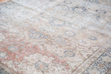 Distressed Kaisary carpet with faded ivory, blue, and dusty burgundy scrolling vine motifs.