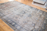 Distressed vintage Turkish Kaisary rug's intricate border with faded charcoal and ivory floral vines.