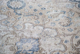 Distressed hand knotted Kaisary rug with intricate scrolling vine and floral motifs.