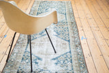 Textured distressed Malayer runner, with geometric motifs in ivory, beige, and navy blue.