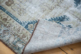 Distressed Malayer runner showcasing ivory, beige tones, a navy geometric border, and its woven backing.