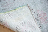 Reverse view of the distressed hand-knotted Oushak carpet, showing foundation and selvedge.