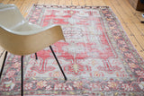 Distressed vintage Oushak rug with faded red, ivory, and saffron floral-like renderings.