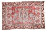 Distressed Oushak carpet, faded cinnabar red and ivory field, rams horn medallion, floral borders, 5' x 7'8