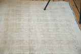 Distressed Tulu rug texture with subtle interlatched patterns, ivory, beige, and soft celadon abrashes.